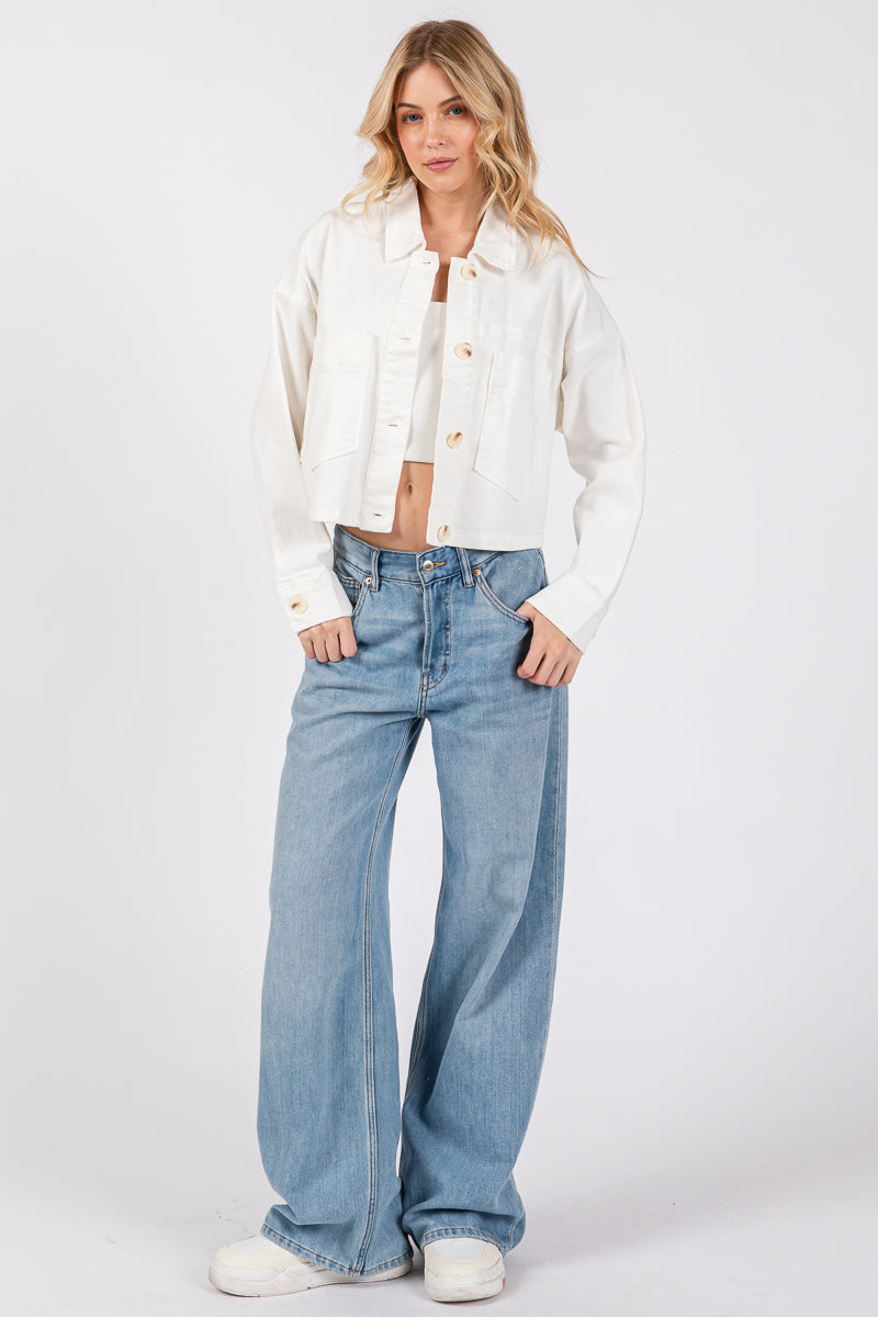 cropped denim-style jacket with button-down front worn over wide-leg jeans, showcasing a chic casual outfit in white.